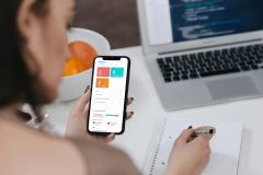dockflow-blockchain-powered-logistics-web-application-1748011814-e7431c2b-4b3a-4ad4-adae-5df20e28af7c-holding-iphone-at-desk-dashboard.png